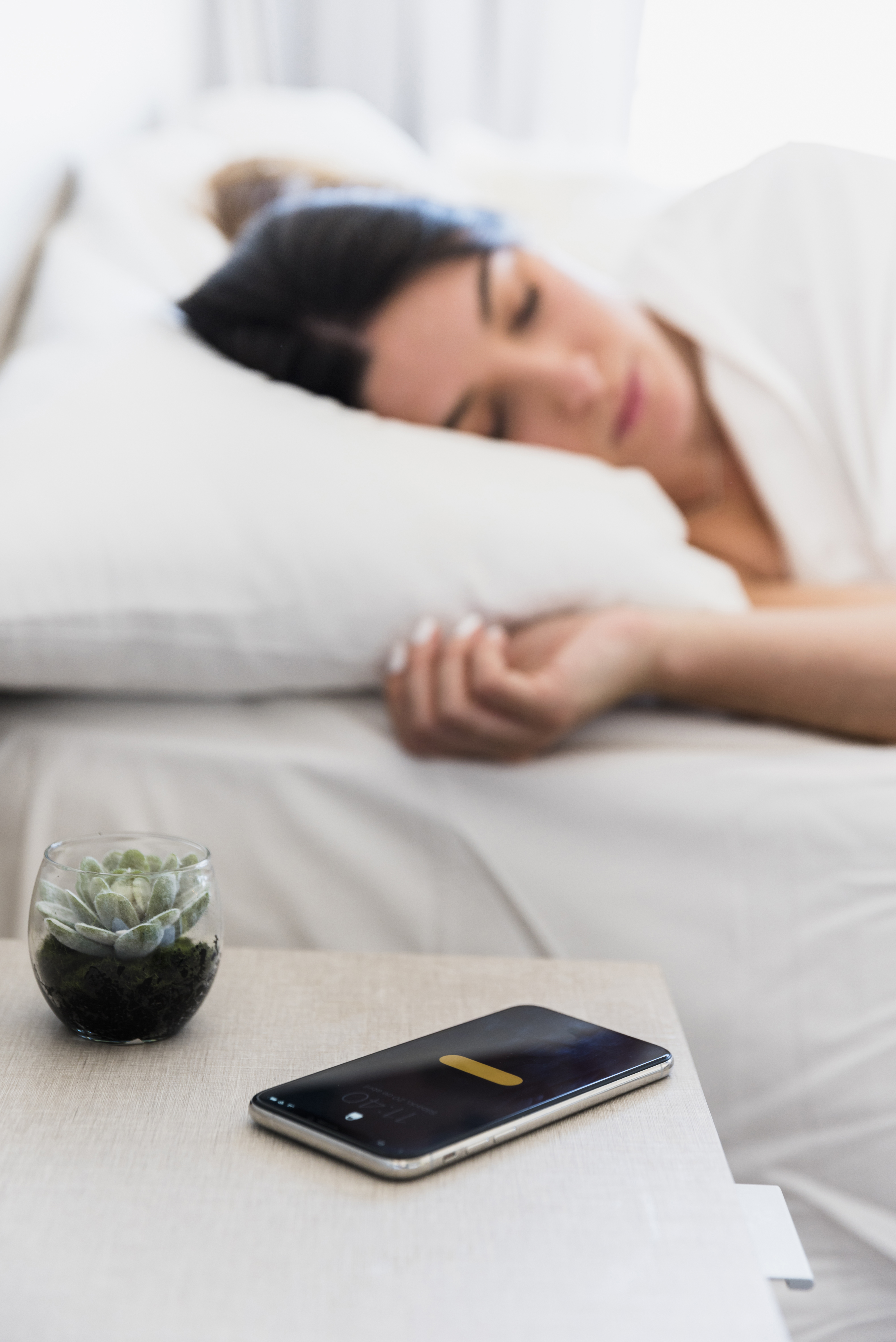 cactus-plant-smartphone-table-near-woman-sleeping-bed