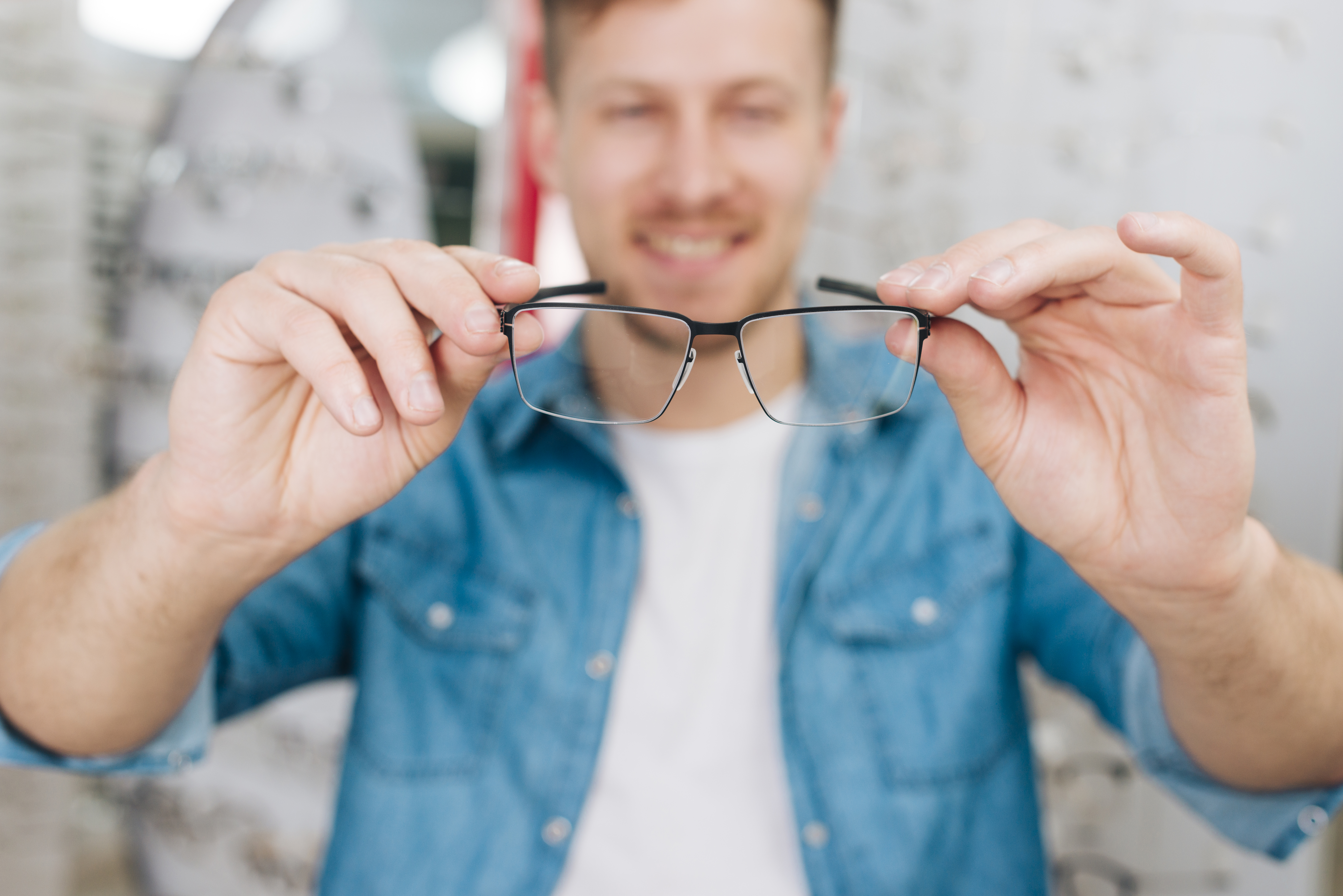 man-looking-new-glasses-optometrist
