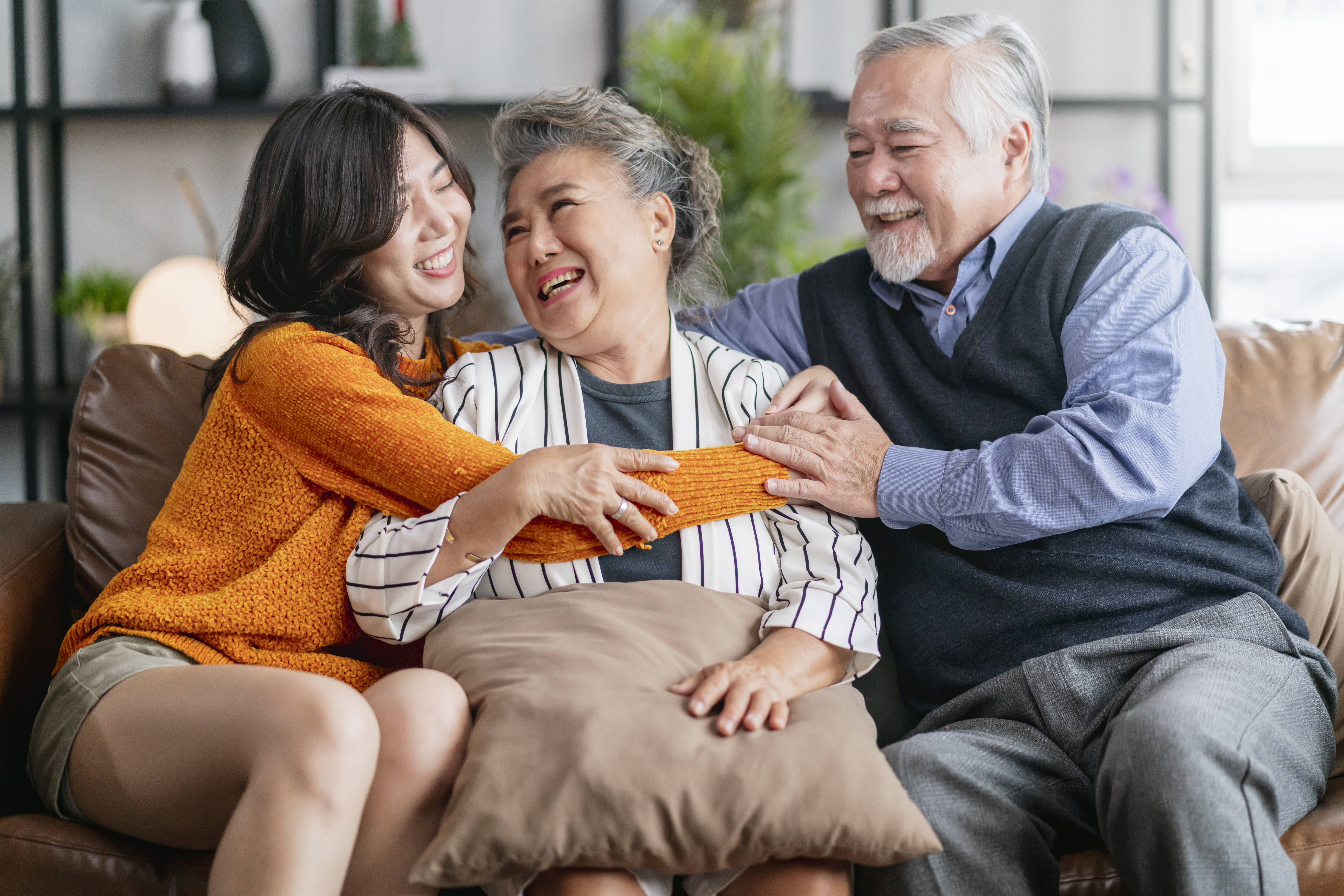 happiness-asian-family-candid-daughter-hug-grandparent-mother-farther-senior-elder-cozy-relax-sofa-couch-surprise-visiting-living-room-hometogether-hug-cheerful-asian-family-home